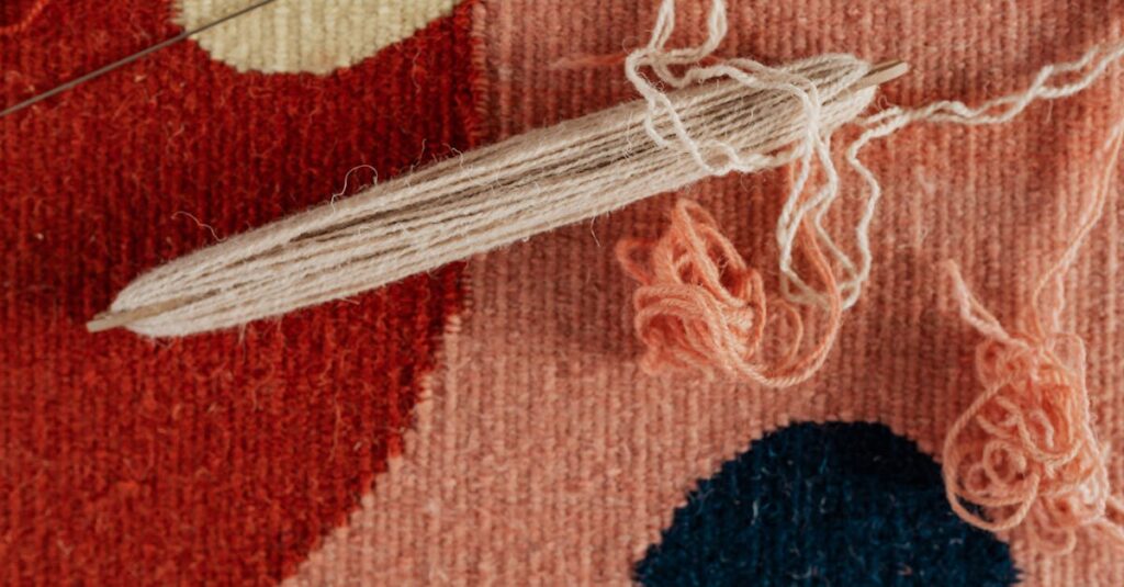 Detailed view of a weaving process with yarn and shuttle, showcasing textile craftsmanship.