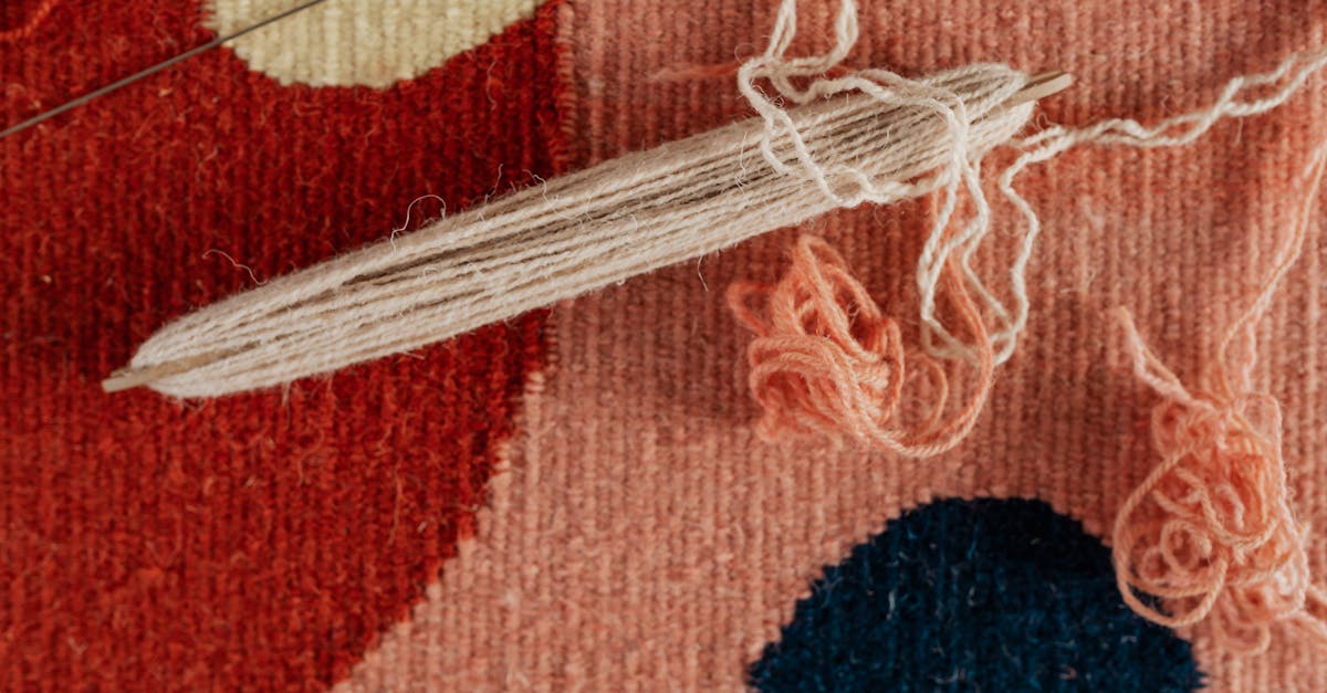 Detailed view of a weaving process with yarn and shuttle, showcasing textile craftsmanship.